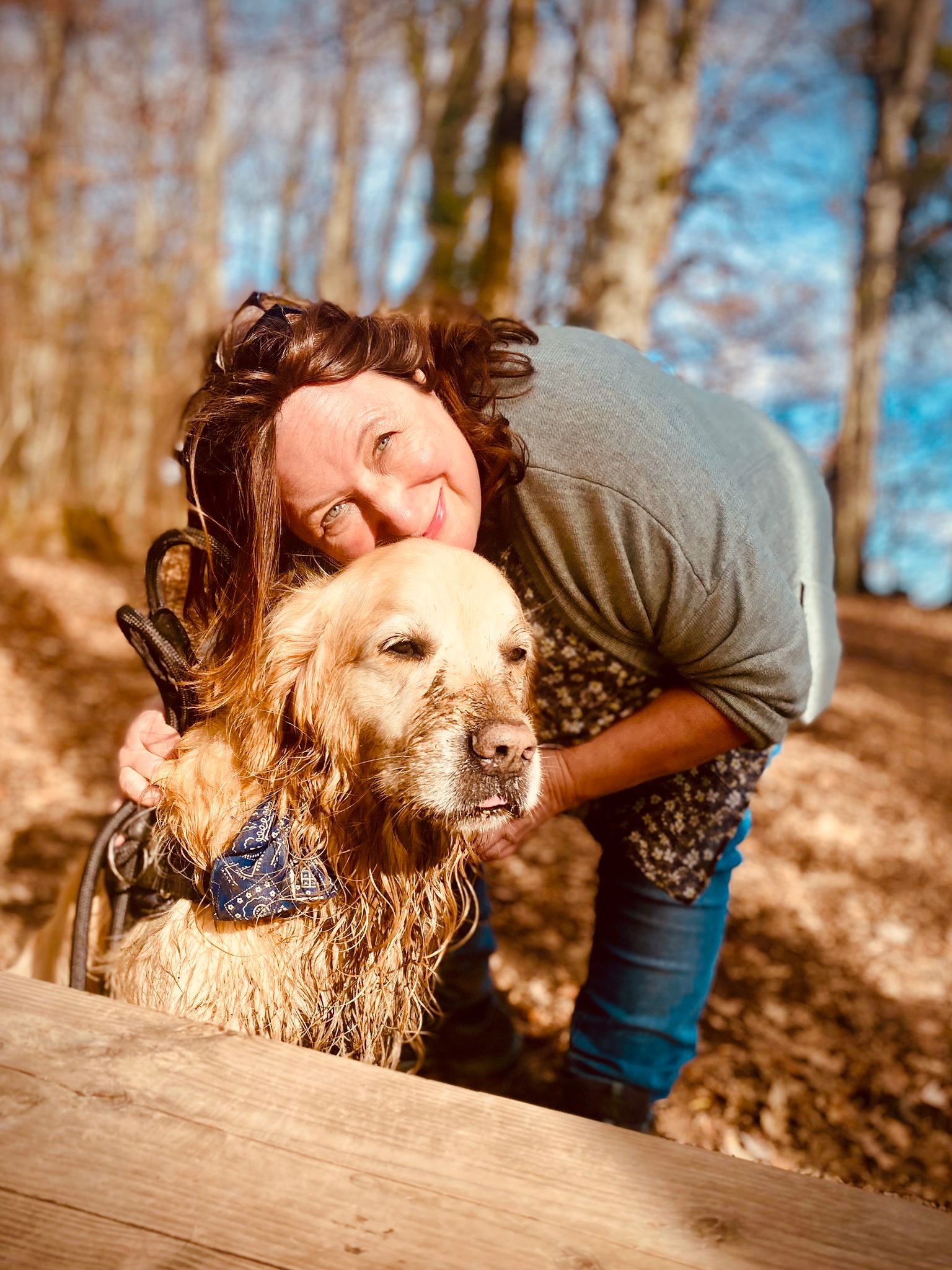 Woman hugging golden retriever dog